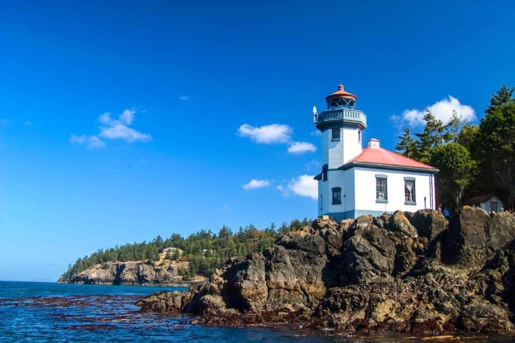 Small lighthouse on roky shore of San Juan Island Washington State.