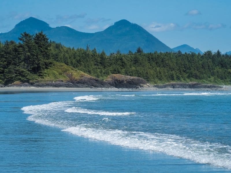 Long Beach, Tofino with mountains in the background.