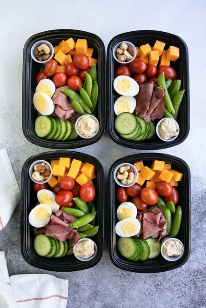 Four trays of protein & veggies lunches. 