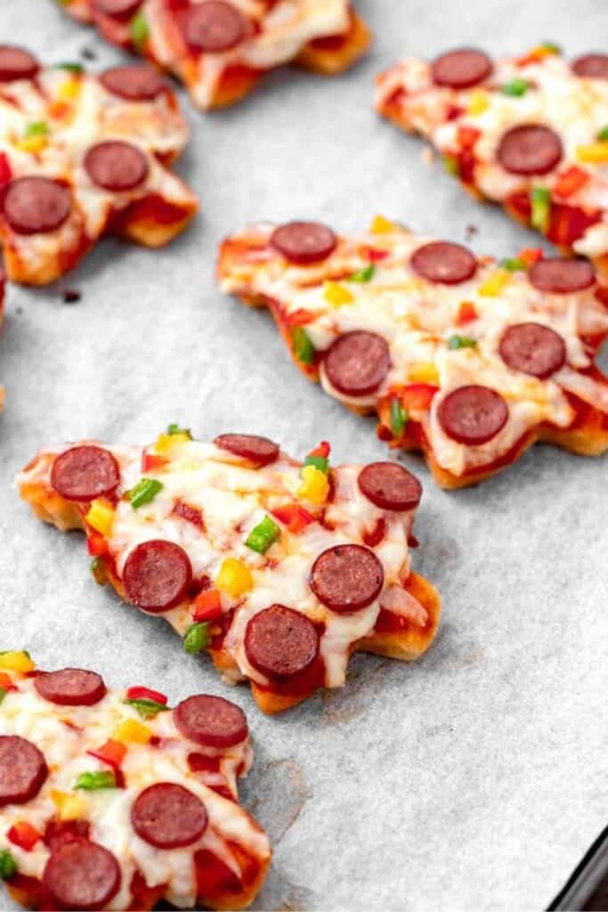 Close up of Mini pizza Christmas trees made with pepperoni, cheese and small peppers for ornaments