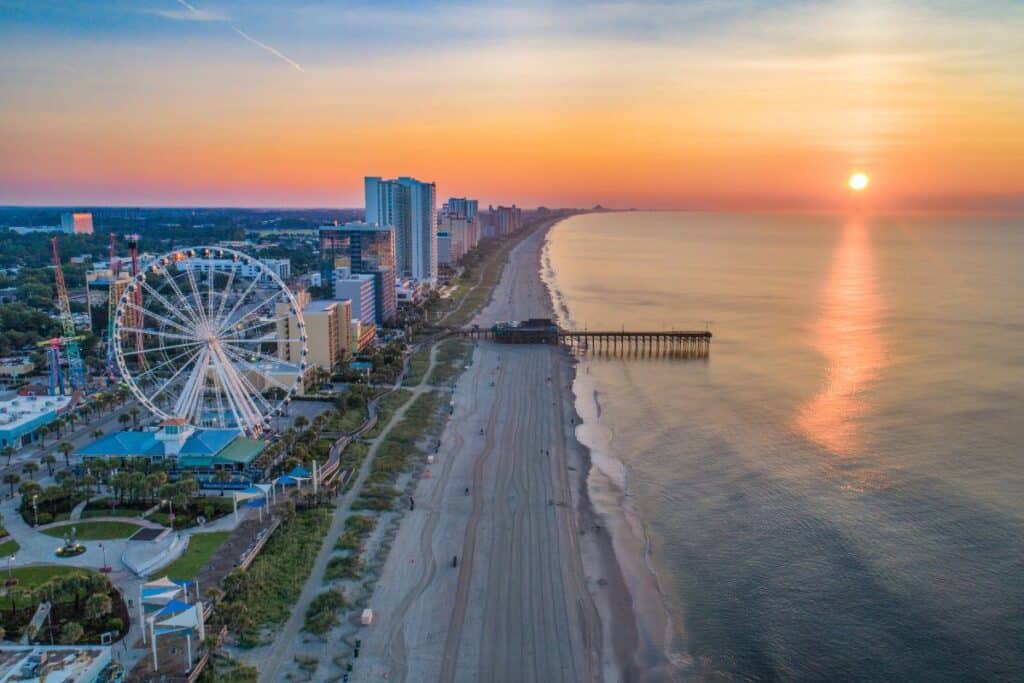 Ferris Wheel & sandy beach at sunset in Myrtle Beach.