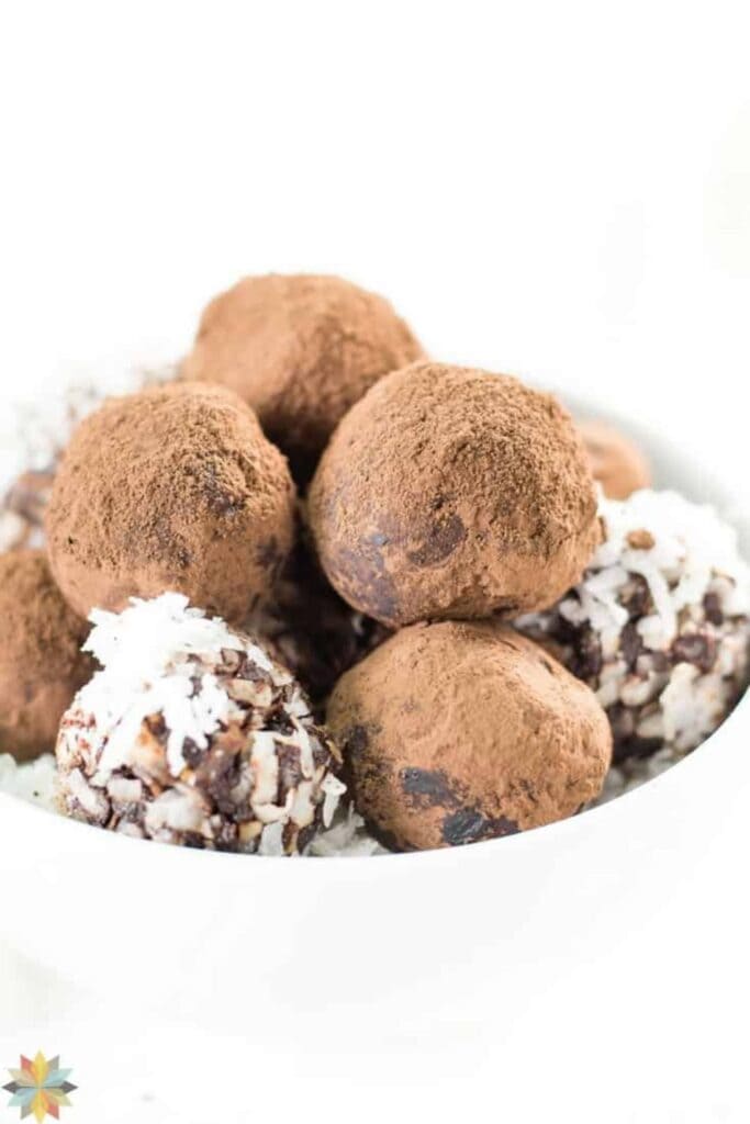 Bowl of chocolate avocado truffles dipped in cocoa and coconut 