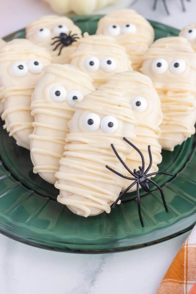 Plate of Nutter Butter cookies in white candy melt to look like mummies.