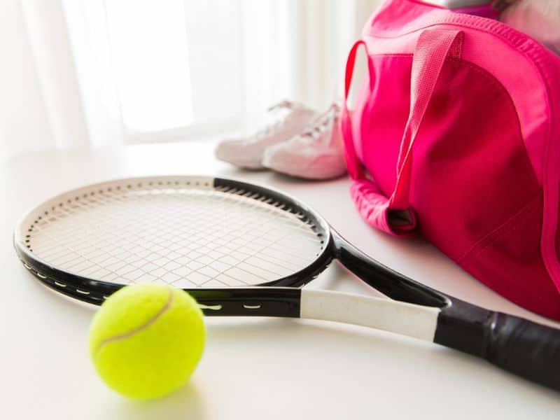 Tennis racket, ball and bag.