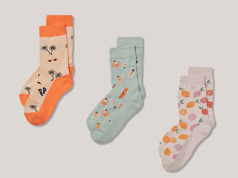 Three pairs of Pact organic socks with fuit, beach and tropical themes.