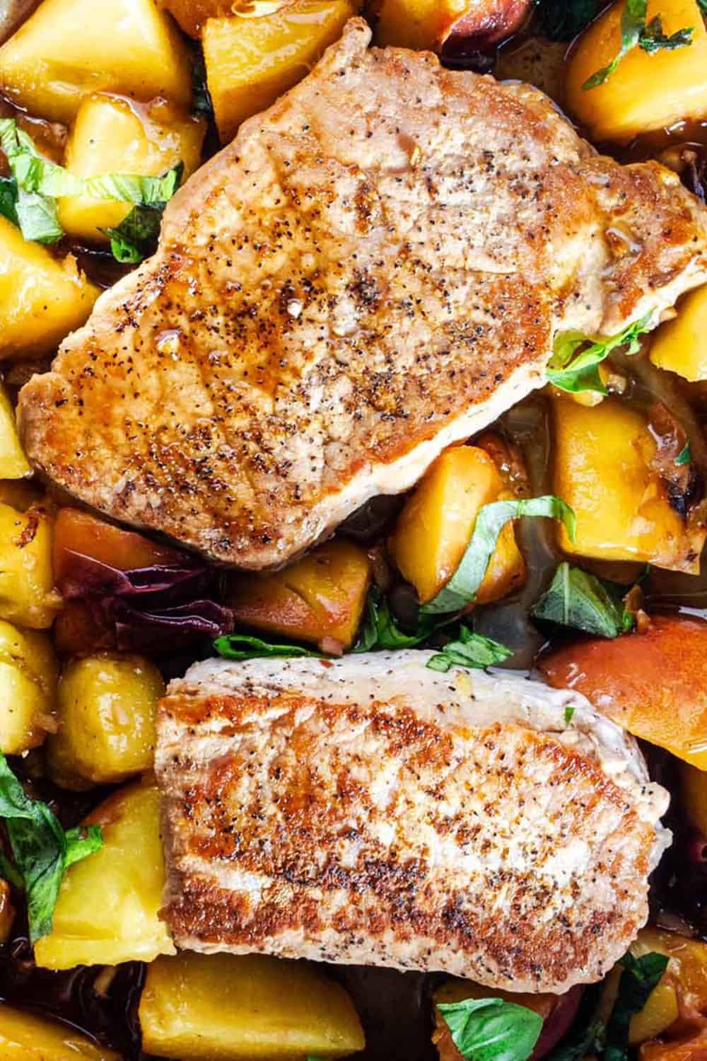 Golden brown pan-seared pork chops served with tender peaches, caramelized red onions, and fresh basil in a savory pan sauce. These pan seared pork chops with peaches combine juicy fruit and flavorful pork for an easy skillet dinner.
