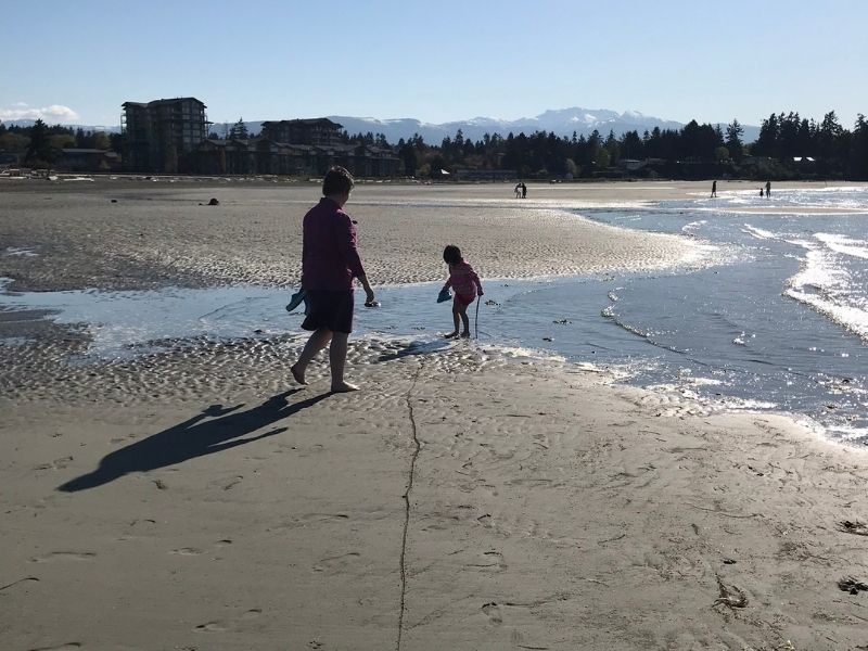 Parksville Beach. Mom and daughter barefoot on beach.