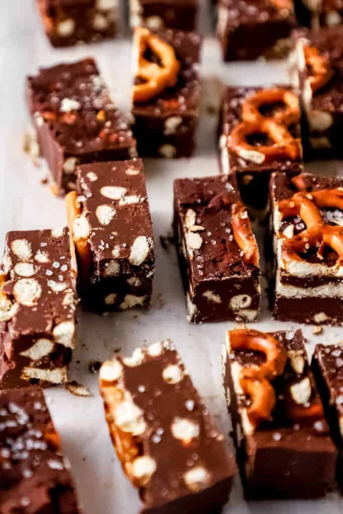 Rectangular pieces of rich chocolate pretzel fudge, packed with crunchy pretzel chunks and topped with flaky sea salt.