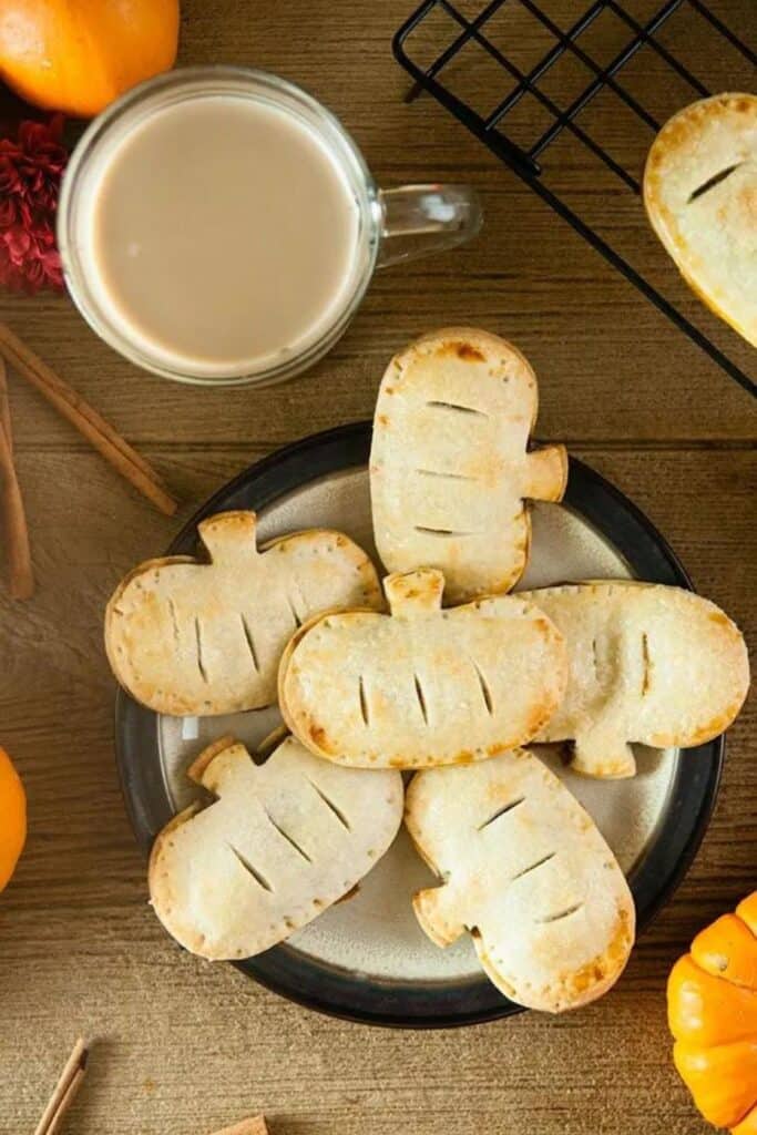 Plate of 7 pumpkin shaped, pumpkin hand pies. 