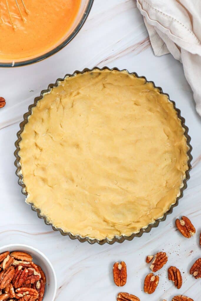 Scalloped baking dish with unbaked dough inside