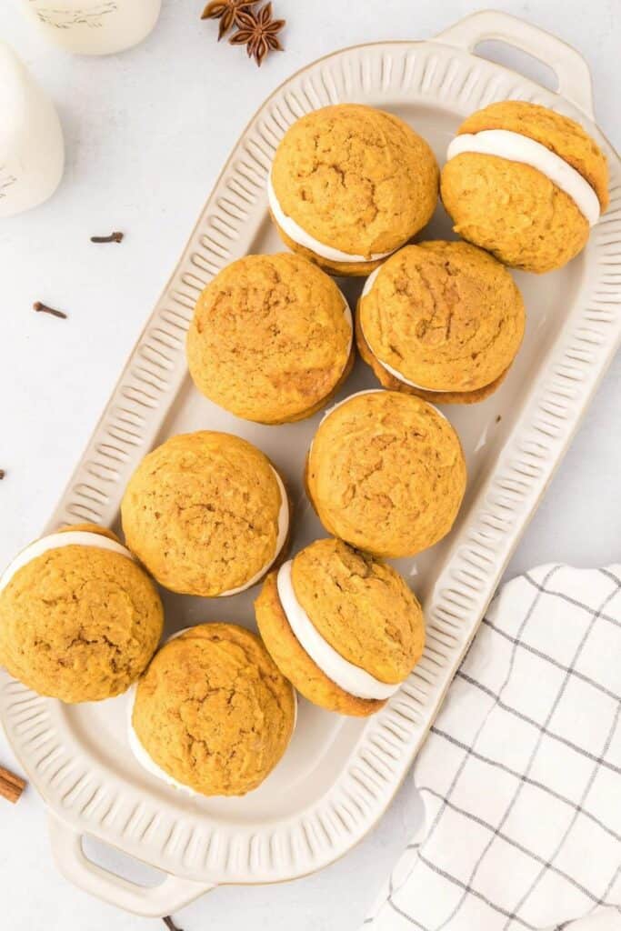 Rectangular plate filled with pumpkin whoopie pies. 