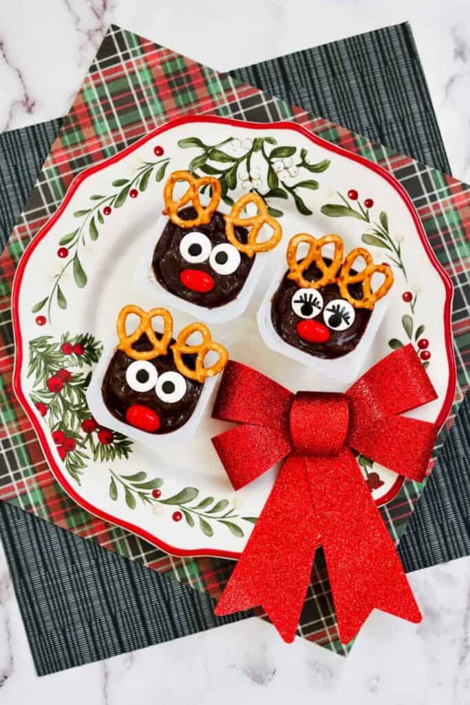 Reindeer chocolate pudding cups, with pretzel antlers, candy eyes and red candy nose. 