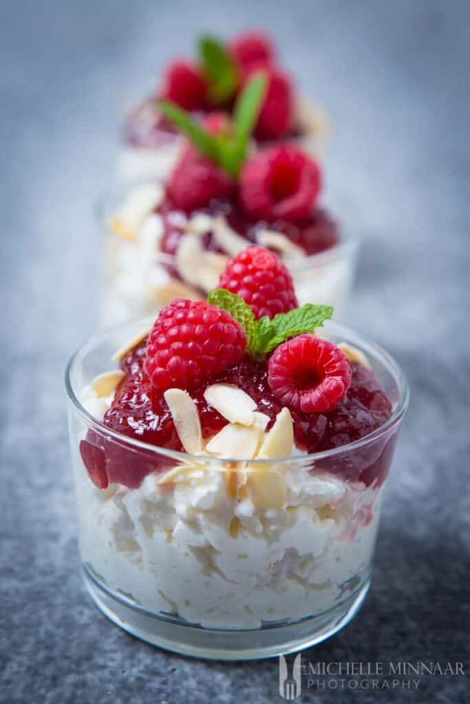 Risalamande Dessert topped with raspberries.