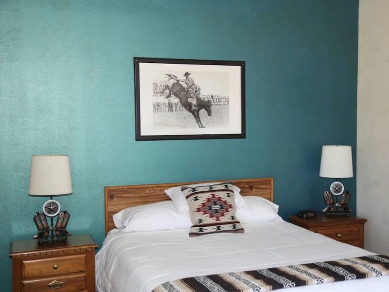 Affordable places to stay between Zion & Bryce; bedroom at Riverside Ranch Motel. Western themed.