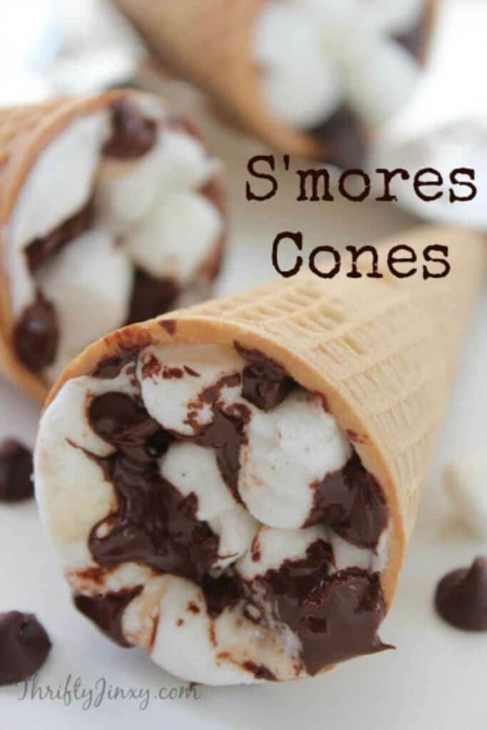 Two sugar cones filled with melted mini marshmallows and chocolate chips. 