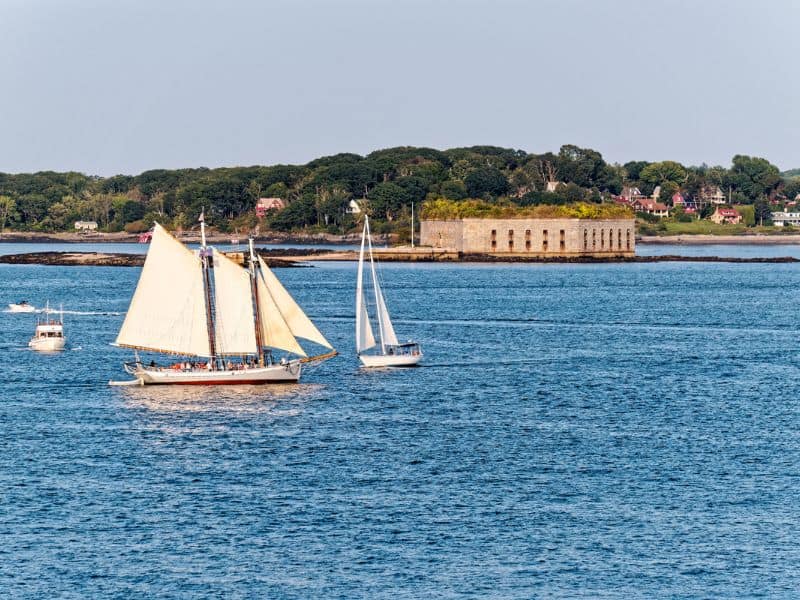 Schooner sailing past Fort George, Maine. 