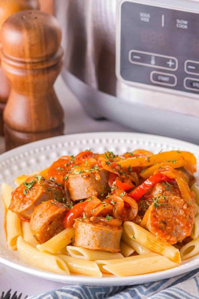 Slow cooker sausages and peppers over penne pasta. 