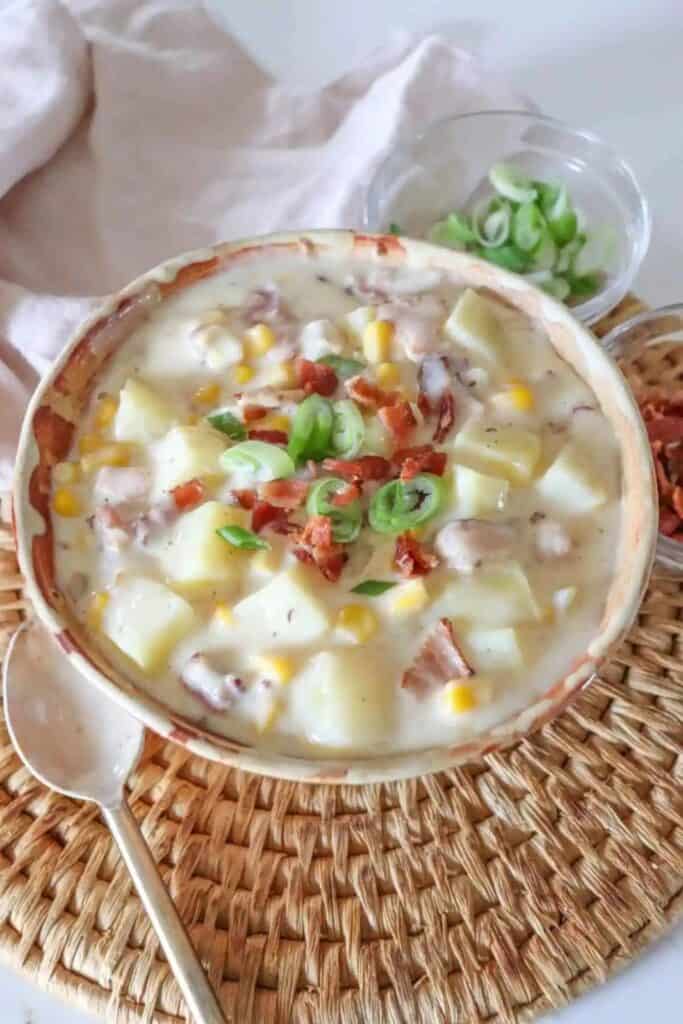 Bowl of creamy loaded potato soup with bacon and corn. 