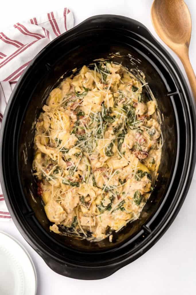 Overhead view of slowcooker with Tuscan Chicken Tortellini pasta dish. 