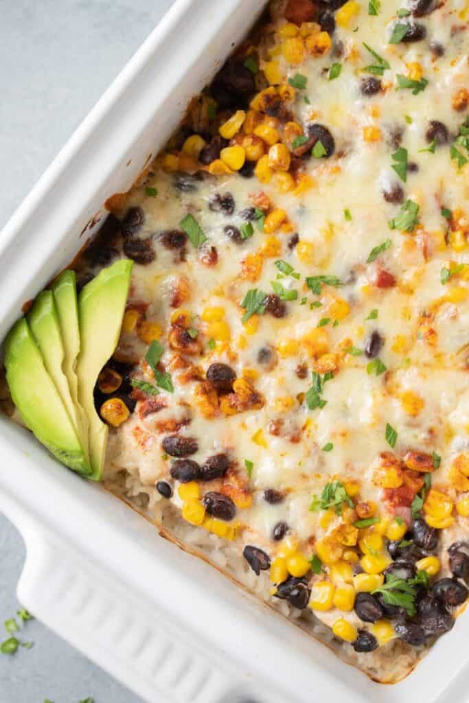 Casserole dish wih melted cheese, black beans, and corn.