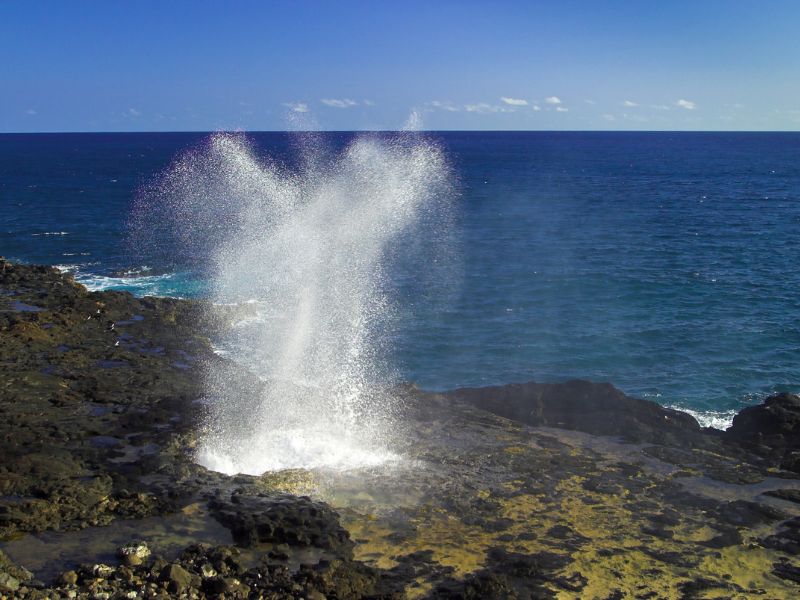 Water spouting out of lava tube. Spouting Horn on Kaua'i, Hawaii