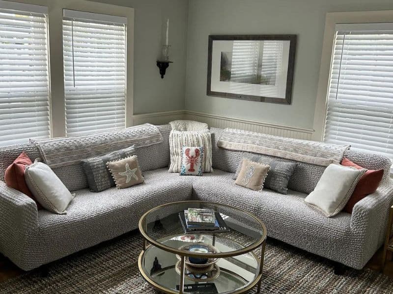 Cozy Maine themed living room with couches and lobster pillow.