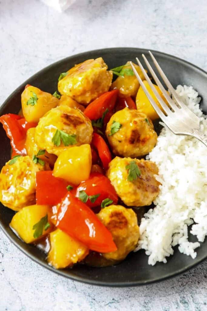 Plate of sweet and sour turkey meatballs and white rice. 