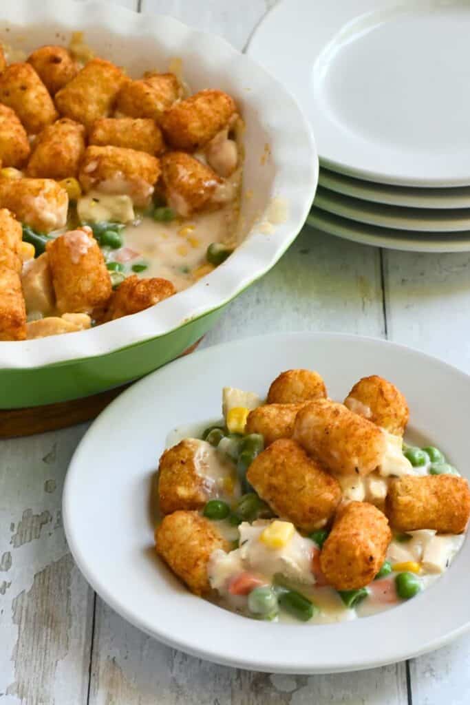 Creamy turkey pot pie casserole with peas, corn and carrots topped with crispy golden tater tots, a comforting choice for easy fall casseroles and family dinners.