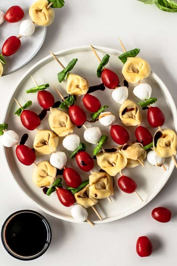 6 Tortellini, mozarella ball and cherry tomotato skewers drizzled in balsalmic glaze. 