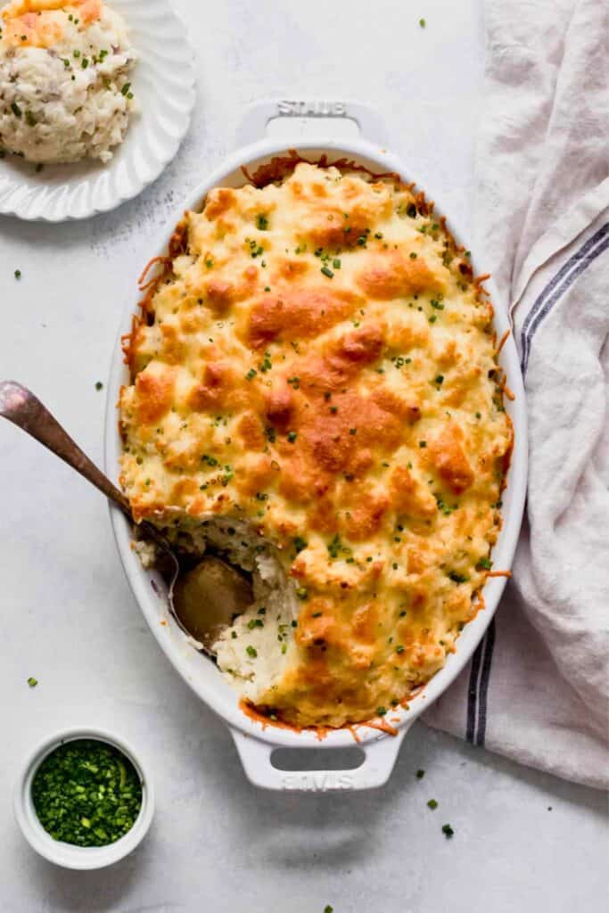 Fall vegetable casserole with creamy mashed potatoes twice baked under a golden cheesy topping and garnished with fresh chives.
