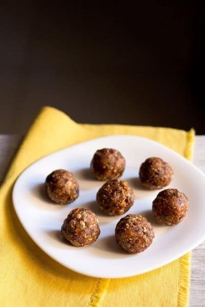 Road Trip Snack Ideas Balls of dried fruit Ladoo on a plate.