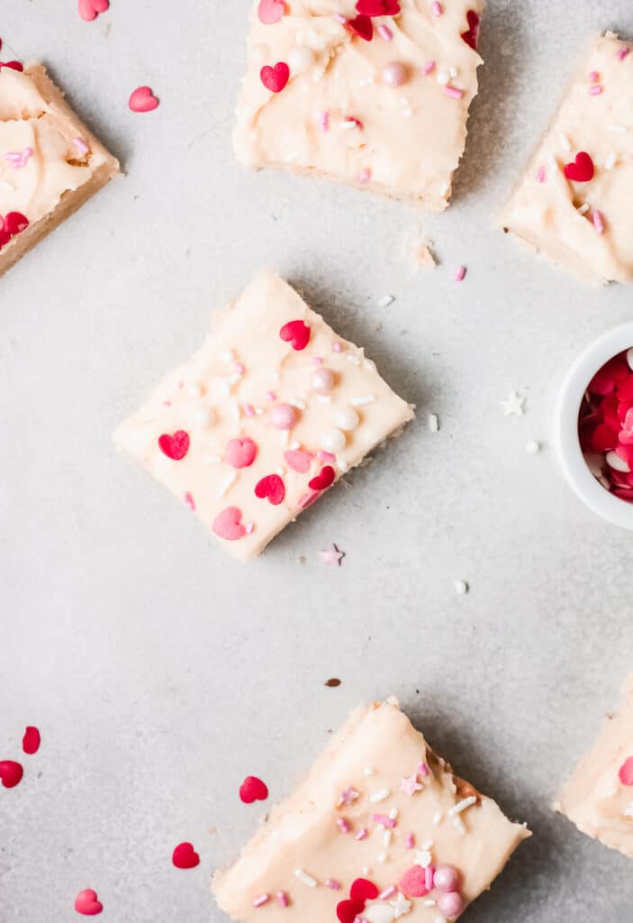Four Valentine's bars with vanilla frosting & heart sprinkles.