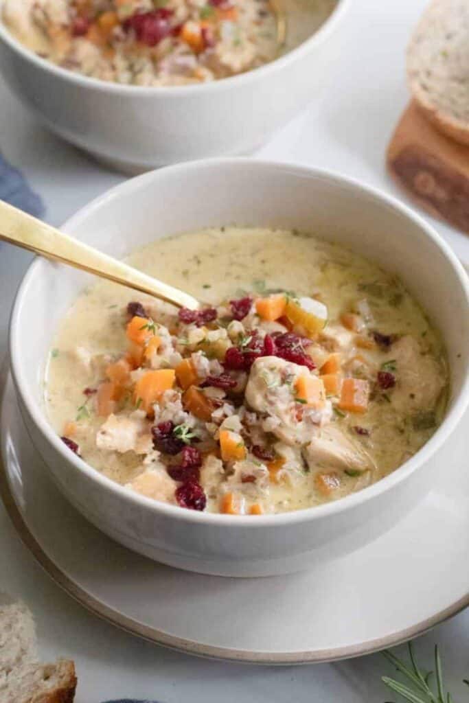 Bowl of creamy Cozy Autumn Wild Rice Soup with cranberries. 