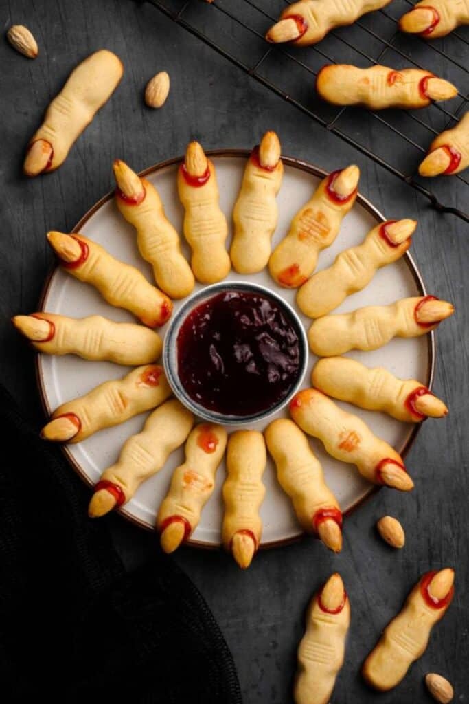 Plate of witches fingers around a blood red sauce.