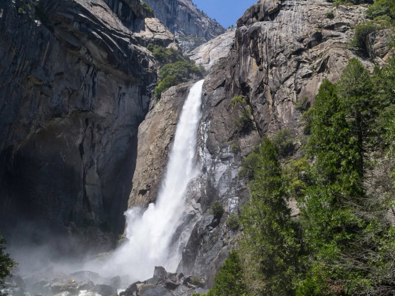 View of Lower Yosemite Falls falling down a rocky mountain.