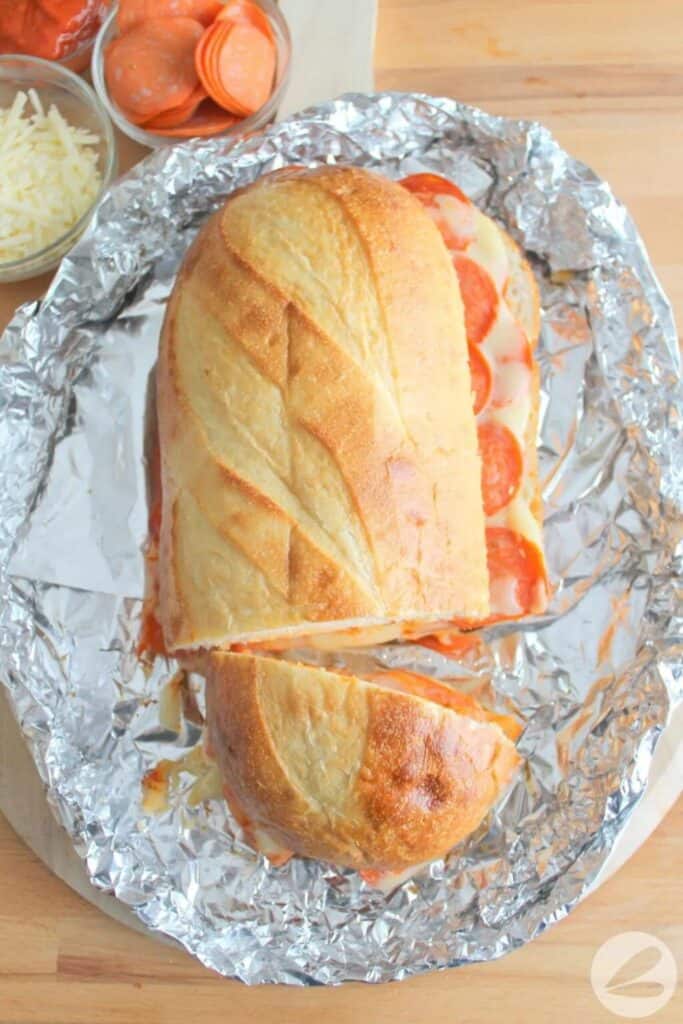 Baguette with pepperoni & cheese on tinfoil.