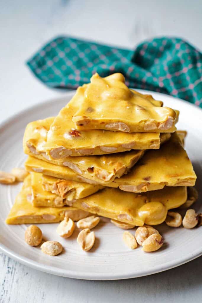 Peanut Brittle pieces piled on a plate. 
